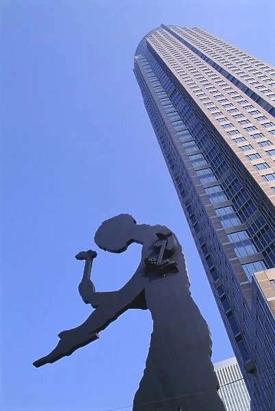 Hammering Man statue and Fair Tower