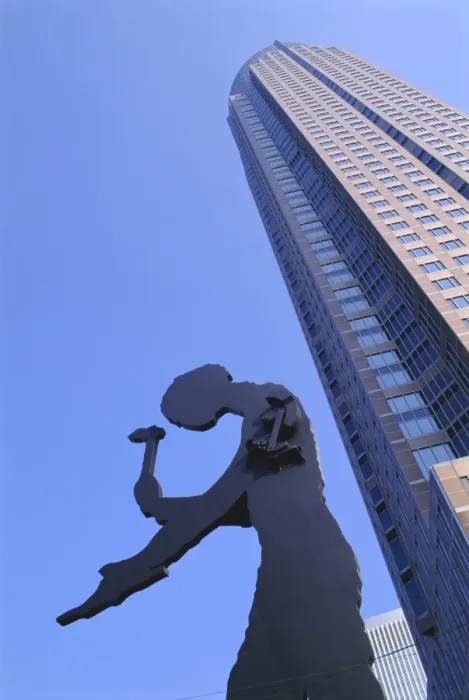 Framed Print : Hammering Man statue and Fair Tower Framed Print : Hammering Man statue and Fair Tower