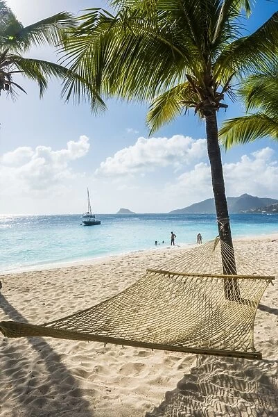 Hammock between two palms on a sandy beach, Palm Island, The Grenadines, St. Vincent and the Grenadines, Windward Islands, West Indies, Caribbean, Central America