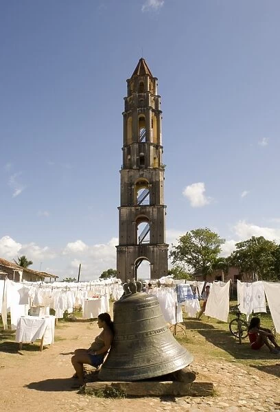 Hand crafted linens for sale beside the Manaca Iznaga Estate Tower and a bell which used to be rung to announce work hours for slaves on the plantation, Valle de los Ingenios, Eastern Cuba, Cuba, West Indies