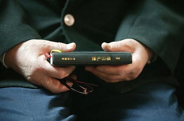Hands holding Bible, Immaculate Conception Cathedral, Beijing, China, Asia