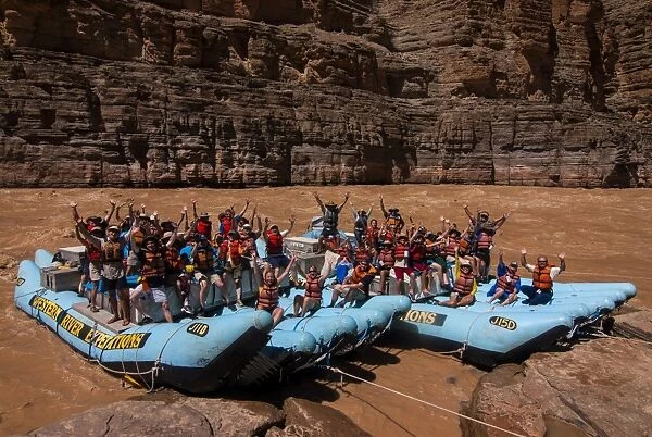Happy tourists on two rafts celebrating, in the beautiful scenery of the Colorado River in the Grand Canyon, Arizona, United States of America, North America
