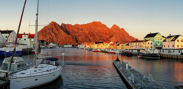 Harbor and village of Henningsvaer at sunset with mountains on background, Nordland county, Lofoten Islands, Norway, Scandinavia, Europe