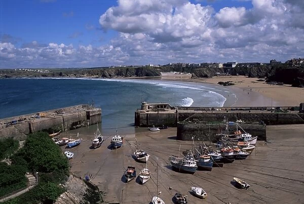 Harbour at low tide with town beach beyond, Newquay, Cornwall, England