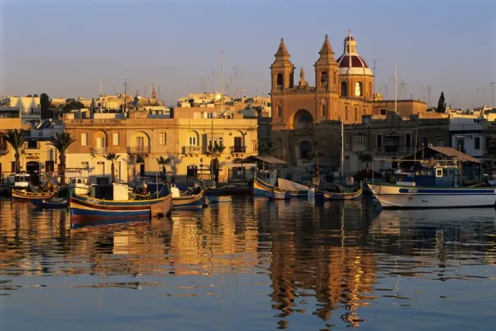 Framed Print : Harbour with Luzzu fishing boats and Marsaxlokk Parish Church at sunrise