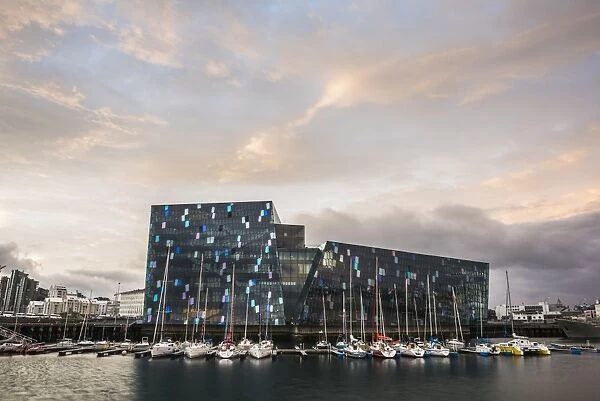 Harpa Concert Hall and Conference Centre and boats in Reykjavik Harbour at sunrise