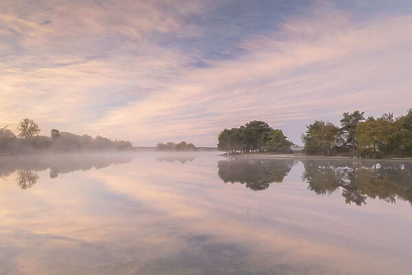 Hatchet Pond reflecting a beautiful pink misty sunrise, Beaulieu, New Forest, England