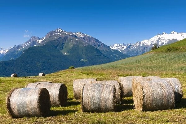 Hay bales, Grivola and Grand Nomenon mountains, Aosta Valley, Italian Alps, Italy, Europe