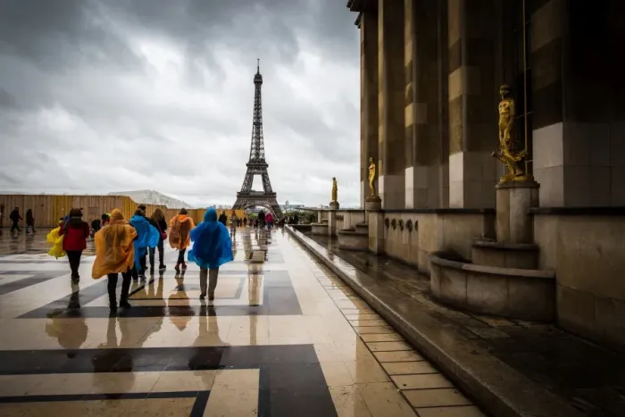Framed Print : Heading towards the Eiffel Tower, tourists brave the rain in colourful ponchos Framed Print : Heading towards the Eiffel Tower, tourists brave the rain in colourful ponchos