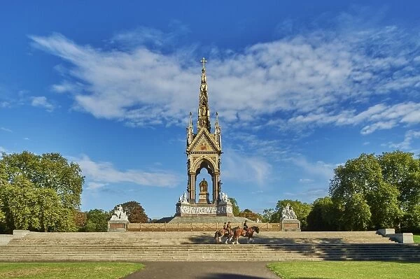 Three heavy horses are ridden past The Albert Memorial, Kensington Gardens, Hyde Park