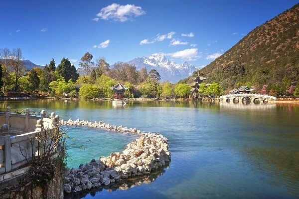 Heilongtan (Black Dragon Pool) with pool, pagodas, white marble bridge and mountain backdrop, Lijiang, Yunnan, China, Asia