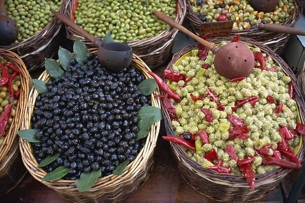 High angle view of baskets of black and green olives on a stall in the market