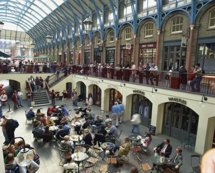 Framed Print : High angle view of people sitting at tables at cafes in the interior of the covered market place at Covent Garden, London, England, United Framed Print : High angle view of people sitting at tables at cafes in the interior of the covered market place at Covent Garden, London, England, United