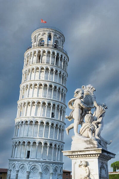 High section of Pisa Leaning Tower and marble statues of fountain