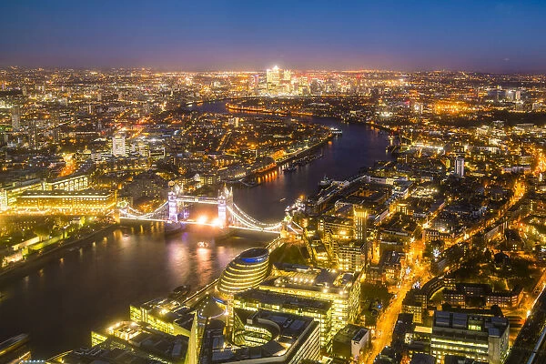 High view of London skyline at night along the River Thames from Tower Bridge to Canary Wharf