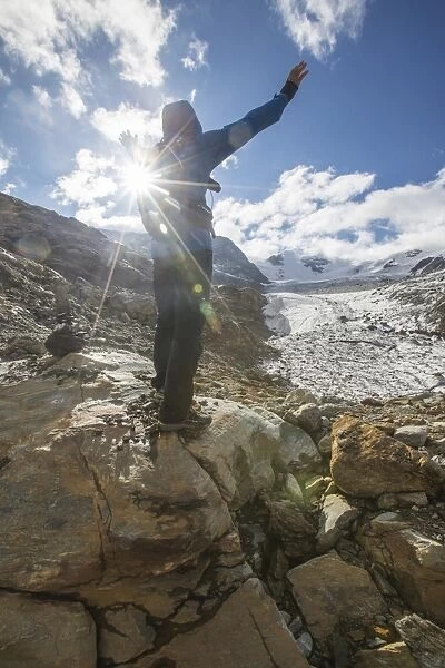 Hiker admires Forni Glacier, Cedec Valley, Stelvio National Park, Valtellina, Lombardy