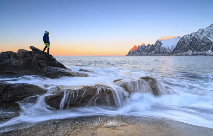 Framed Print : Hiker admires the waves of the icy sea crashing on the rocky cliffs at dawn, Tungeneset Framed Print : Hiker admires the waves of the icy sea crashing on the rocky cliffs at dawn, Tungeneset