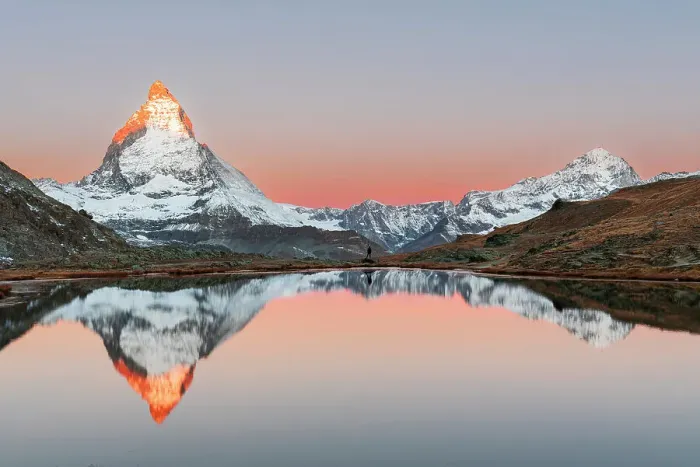 Framed Print : Hiker admiring the Matterhorn reflected in the Riffelsee lake at sunrise, Gornergrat, Zermatt, canton of Valais, Switzerland, Europe