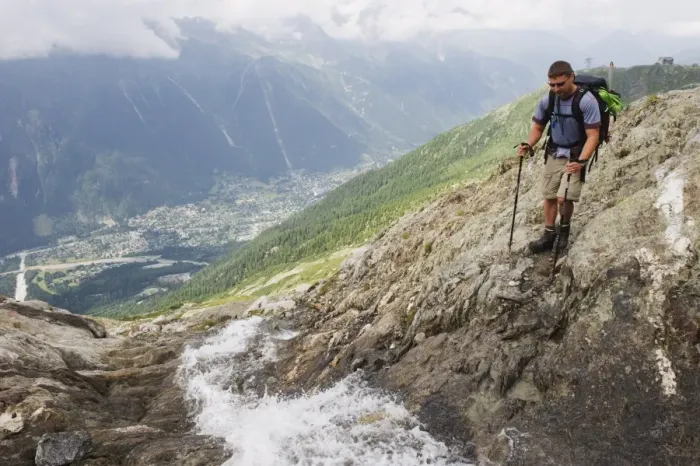 Framed Print : Hiker crossing a stream above Chamonix Valley, Rhone Alps, France, Europe