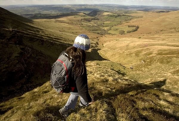A hiker enjoys solitude in the hills above Hay-on-Wye, on the eastern edge of the Brecon Beacons National Park, Monmouthshire, Wales, United