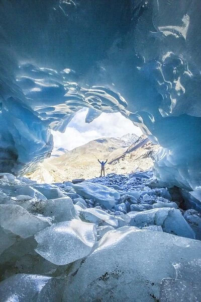 Hiker inside Forni Glacier, Forni Valley, Stelvio National Park, Valtellina, Lombardy