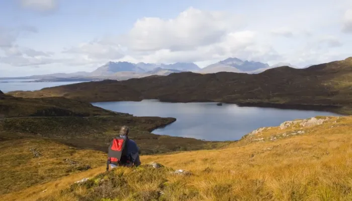 Framed Print : Hiker looking across Loch Dhughaill towards the distant Cuillin Hills, Sleat Peninsula Framed Print : Hiker looking across Loch Dhughaill towards the distant Cuillin Hills, Sleat Peninsula