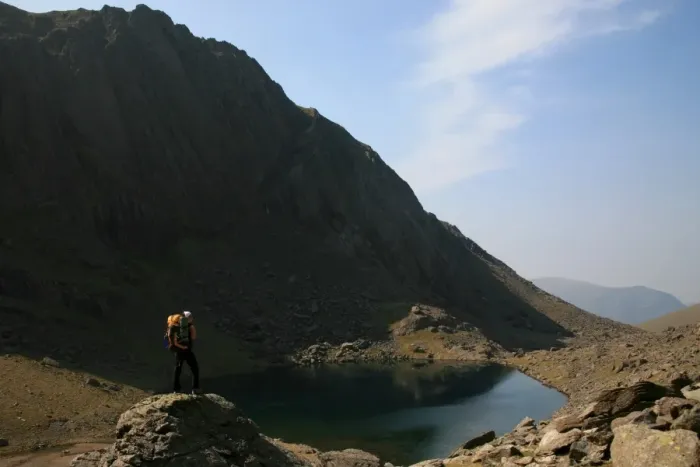 Framed Print : A hiker looks across the still waters of Llyn Du r Arddu, one of Waless highest lakes Framed Print : A hiker looks across the still waters of Llyn Du r Arddu, one of Waless highest lakes