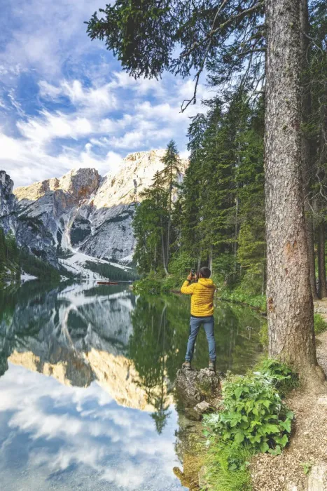 Framed Print : Hiker man photographing Lake Braies (Pragser Wildsee) with smartphone at sunrise Framed Print : Hiker man photographing Lake Braies (Pragser Wildsee) with smartphone at sunrise
