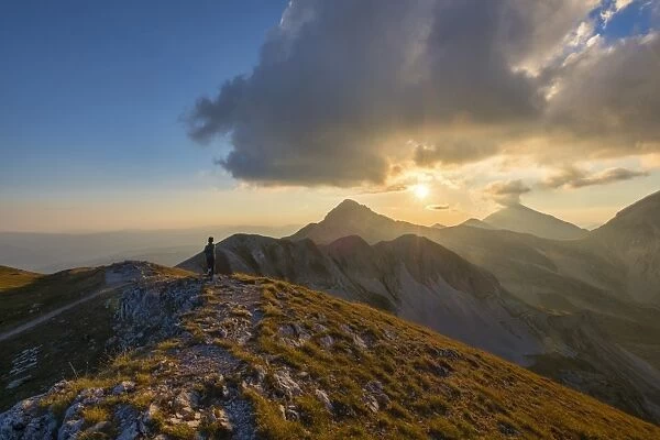 Hiker in front of mountain Portella at sunset, Gran Sasso e Monti della Laga National Park