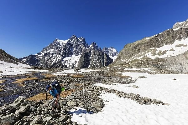 Hiker on a mountain trail, Barre des Ecrins, Ecrins National Park, French Dauphine Alps