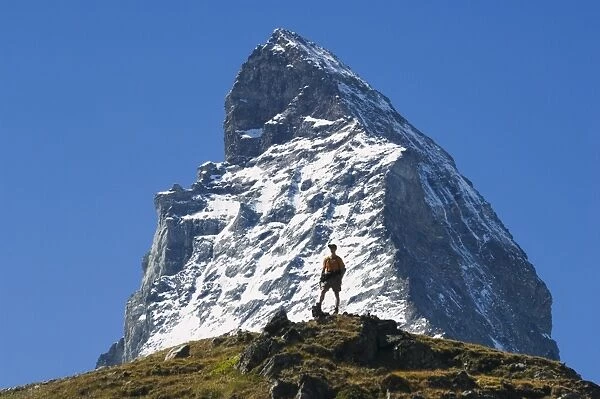 Hiker below the peak of the Matterhorn
