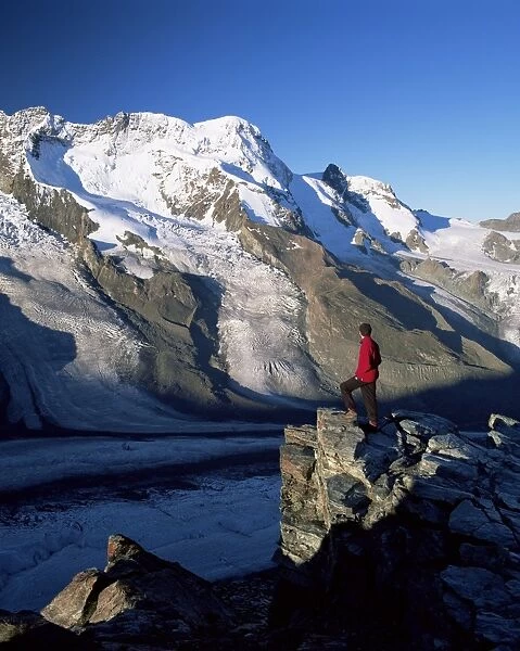 Hiker and view to the Breithorn and Breithorn Glacier
