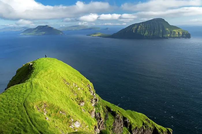 Framed Print : Hiker walks on top of a tall cliff overlooking the ocean, Nordradalur, Streymoy island, Faroe islands, Denmark, Europe Framed Print : Hiker walks on top of a tall cliff overlooking the ocean, Nordradalur, Streymoy island, Faroe islands, Denmark, Europe