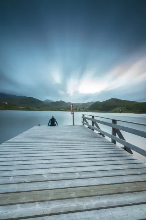 Framed Print : Hiker on wooden deck admires the sea illuminated by blue lights at night, Holdalsvatnet Framed Print : Hiker on wooden deck admires the sea illuminated by blue lights at night, Holdalsvatnet