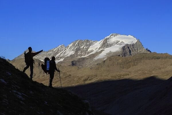 Hikers admire the view of Alpi Graie (Graian Alps) landscape, Gran Paradiso National Park