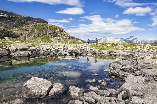 Hikers admire the view at Lake Grevasalvas, Engadine, Canton of Grisons (Graubunden)