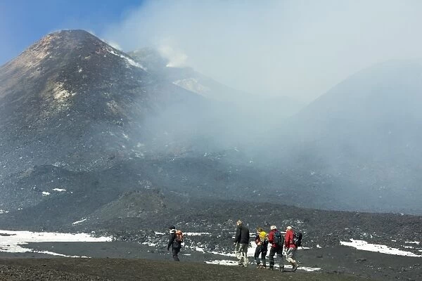 Hikers from the cablecar near the smoking summit of 3350m volcano Mount Etna during an active phase, Mount Etna, UNESCO World Heritage Site, Sicily, Italy, Mediterranean, Europe