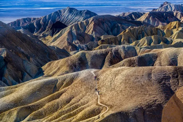 Framed Print : Hikers in the colourful sandstone formations, Zabriskie Point, Death Valley, California, United States of America, North America Framed Print : Hikers in the colourful sandstone formations, Zabriskie Point, Death Valley, California, United States of America, North America