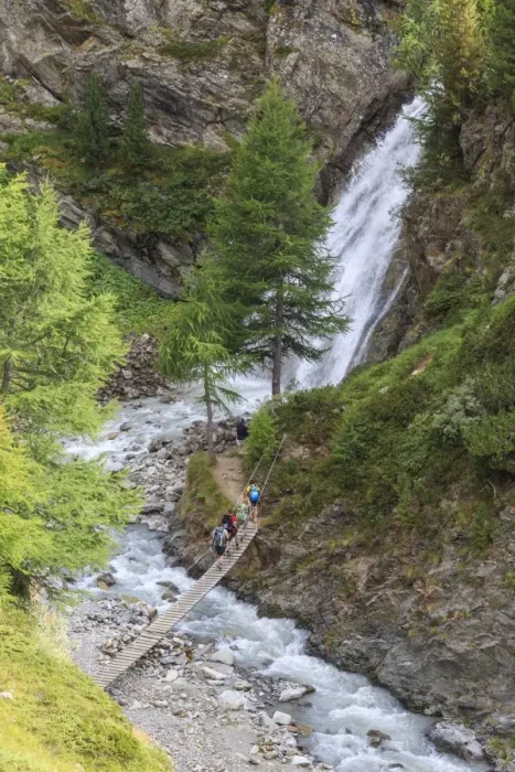 Framed Print : Hikers cross the wooden bridge on a creek in the woods, Minor Valley, High Valtellina Framed Print : Hikers cross the wooden bridge on a creek in the woods, Minor Valley, High Valtellina