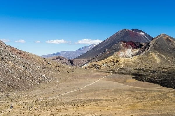 Hikers are dwarfed by the volcanic Mount Ngauruhoe on the Tongariro Crossing trail