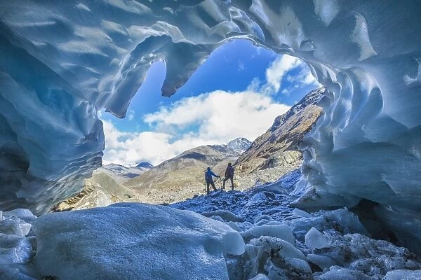 Hikers inside Forni Glacier, Forni Valley, Stelvio National Park, Valtellina, Lombardy