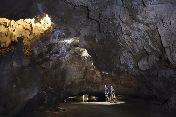 Hikers in the interior of Galaxy cave on the Ben Dang River in Thien Ha, Ninh Binh