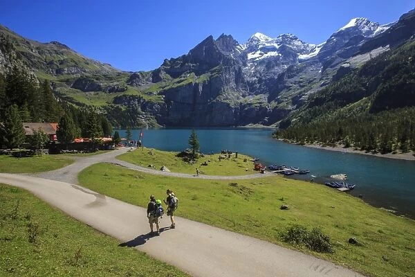 Hikers around Lake Oeschinensee, Bernese Oberland, Kandersteg, Canton of Bern, Switzerland
