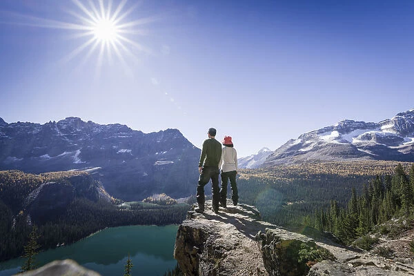 Hikers looking at the view of Alpine mountains and Lake O Hara from the Alpine circuit trail