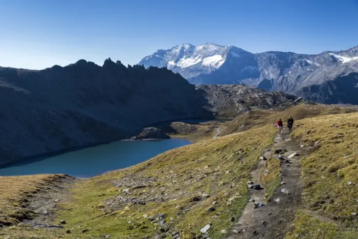 Framed Print : Hikers walking on the Colle del Nivolet beside Rossett Lake (Lago Rossett), Gran Framed Print : Hikers walking on the Colle del Nivolet beside Rossett Lake (Lago Rossett), Gran