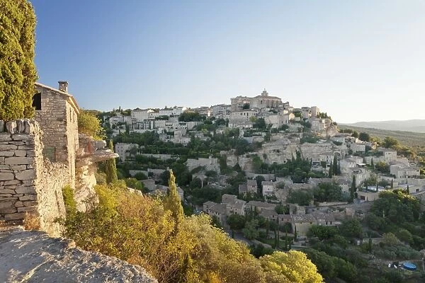 Hilltop village of Gordes with castle and church at sunrise, Provence, Provence-Alpes-Cote d Azur