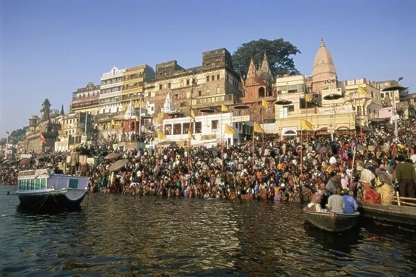 Hindu pilgrims bathing in the early morning in the holy river Ganges