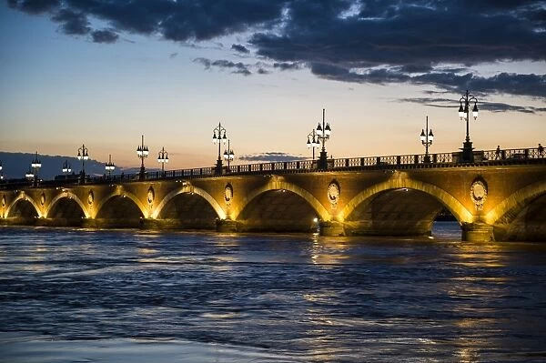 Historic bridge Pont de Pierre over the Garonne River at sunset, Bordeaux, Aquitaine