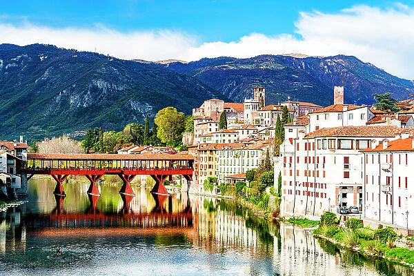 Historic buildings and Ponte Degli Alpini reflected in river Brenta, Bassano Del Grappa, Vicenza province, Veneto, Italy, Europe