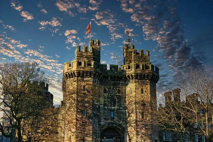 Framed Print : Historic stone castle with towers against a blue sky with scattered clouds at sunset in Lancaster